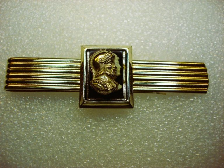 Vintage gold-tone tie clip with onyx inlay and centurion figures