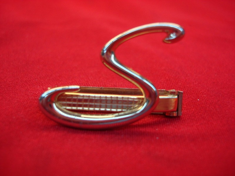 Vintage Swank gold tone tie clip with intricate 'S' design
