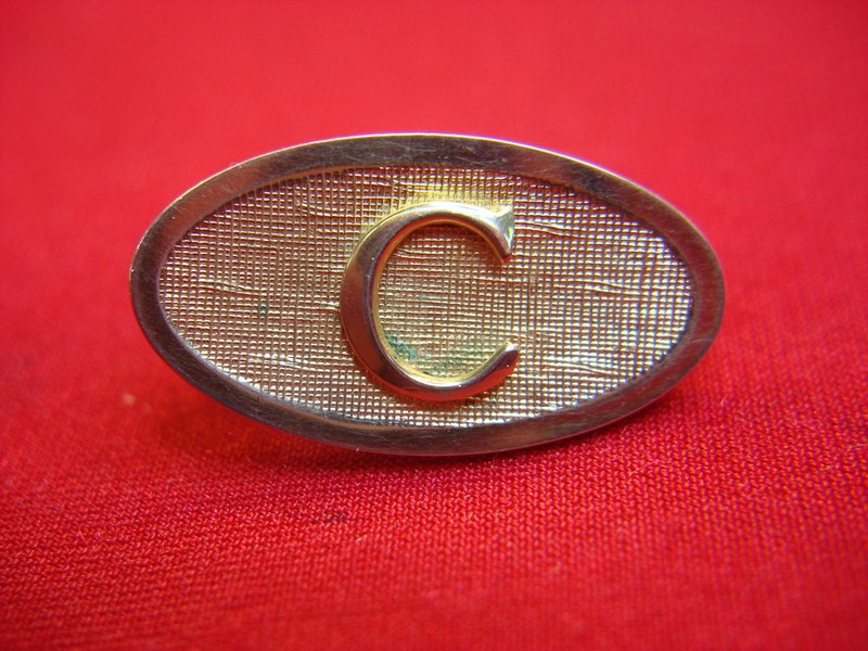 Vintage gold-tone lapel tie clip with 'C' monogram