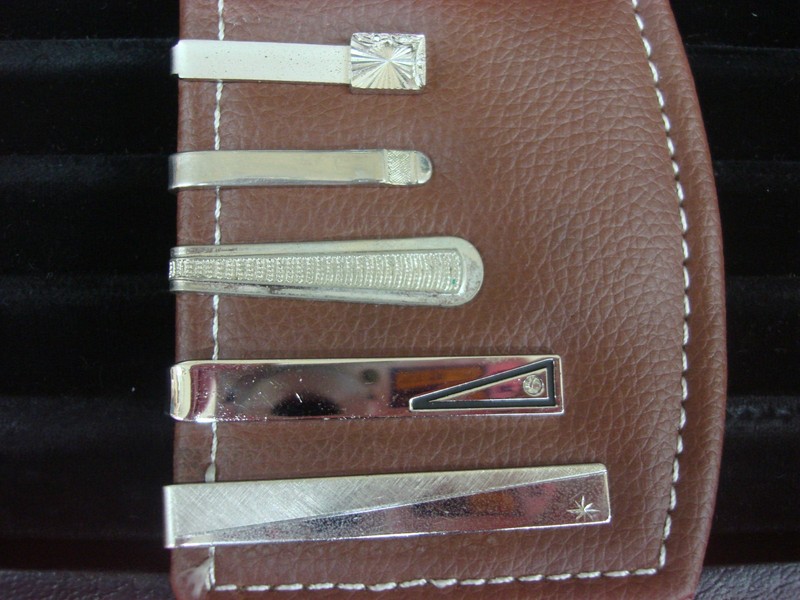 Five vintage silver-tone tie clips in a set, showcasing unique designs.