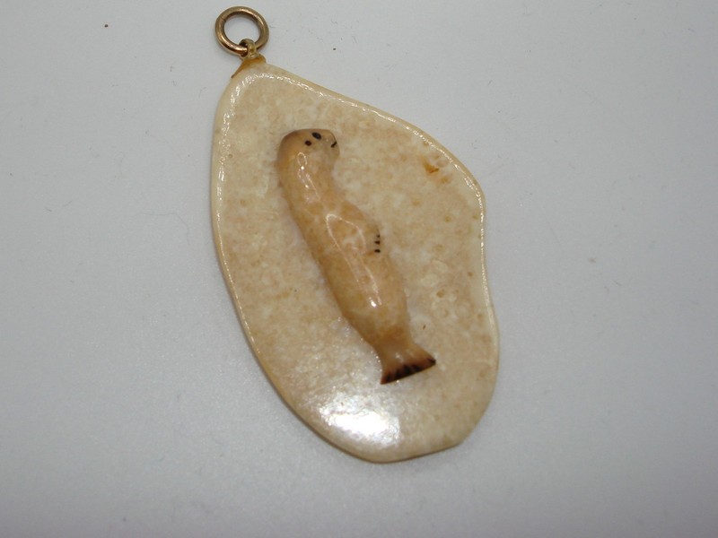 Vintage signed Diomede, Alaska baby seal carved pendant