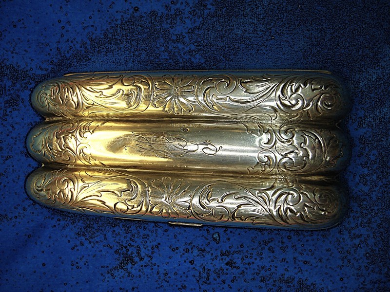 Vintage sterling silver three-finger cigar case with ornate detailing and monogram