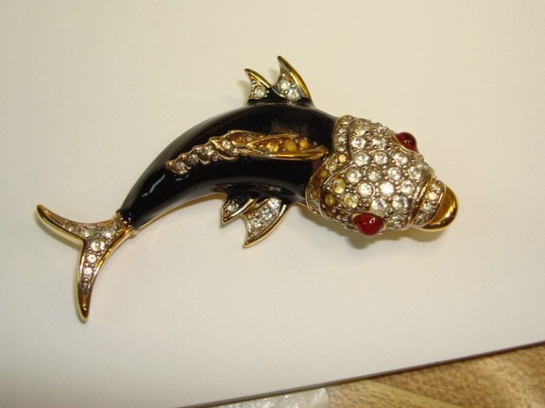 Vintage Nina Ricci koi fish brooch with gold-tone enamel, crystals, and red cabochon eyes.
