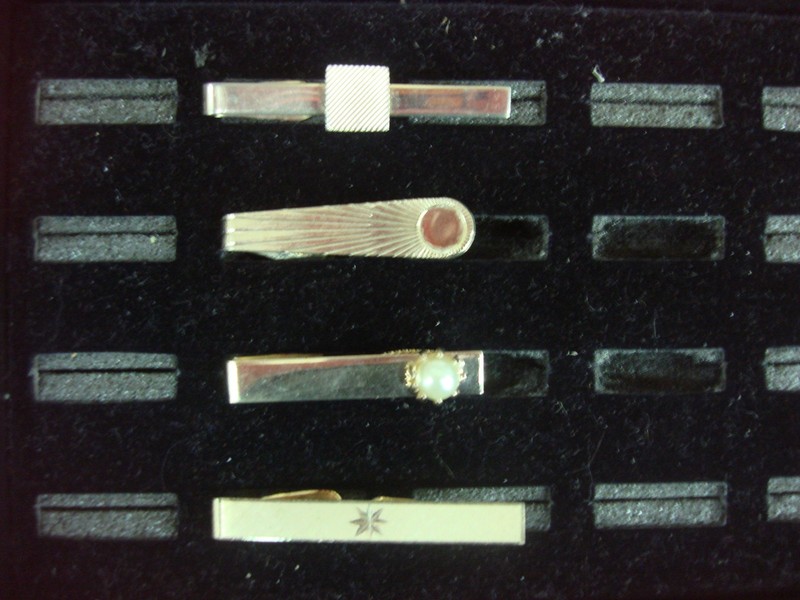 Set of four vintage gold-tone tie clips with unique designs