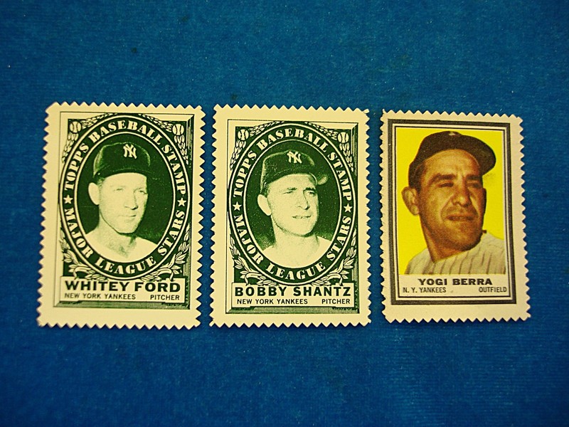 Vintage Topps baseball cards from the 1960s featuring Yogi Berra, Whitey Ford, and Bobby Shantz.