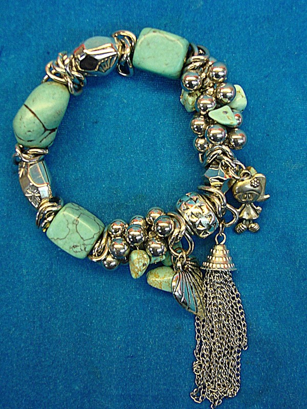 Chunky stretch bracelet with faux turquoise, silver beads and a doll charm