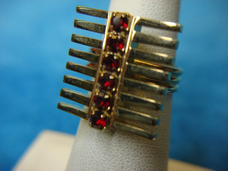 Vintage gold-tone ring with red stone accents, adjustable size 6-8