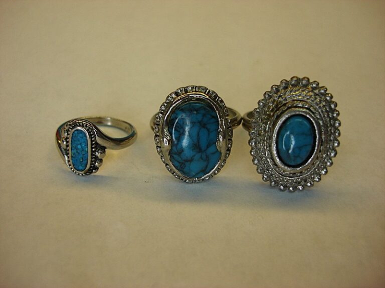 Three silver tone rings with turquoise stones