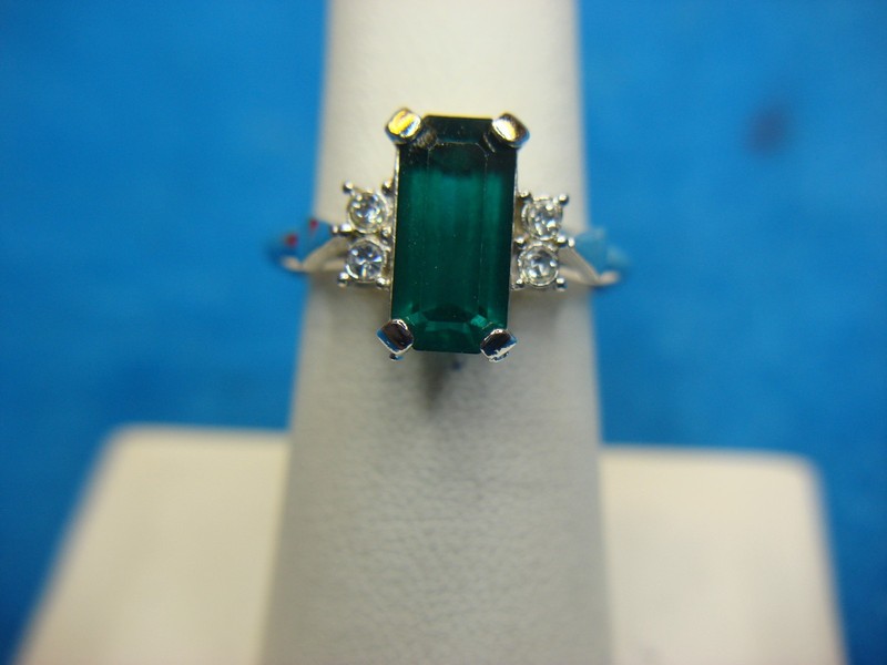 Avon silver-tone ring with a green emerald-cut stone, adjustable size 6.5-9