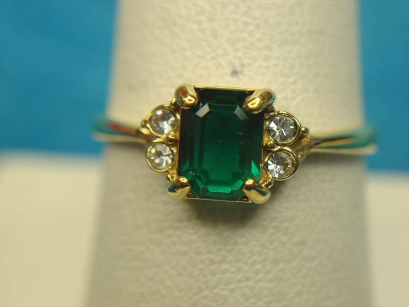 Avon gold-tone ring with green stone and cubic zirconia accents, size 9