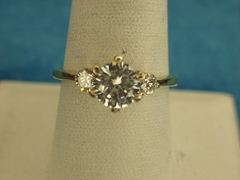 Gold tone fashion ring with a 7mm cubic zirconia stone, size 9