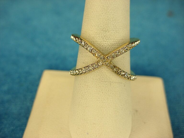 Gold tone ring with round simulated diamonds, size 8 3/4, unique X design