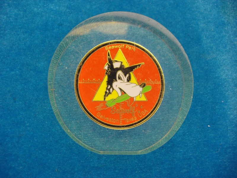 Vintage Seawolf Park Galveston coin display featuring an enameled coin design in a lucite disk.