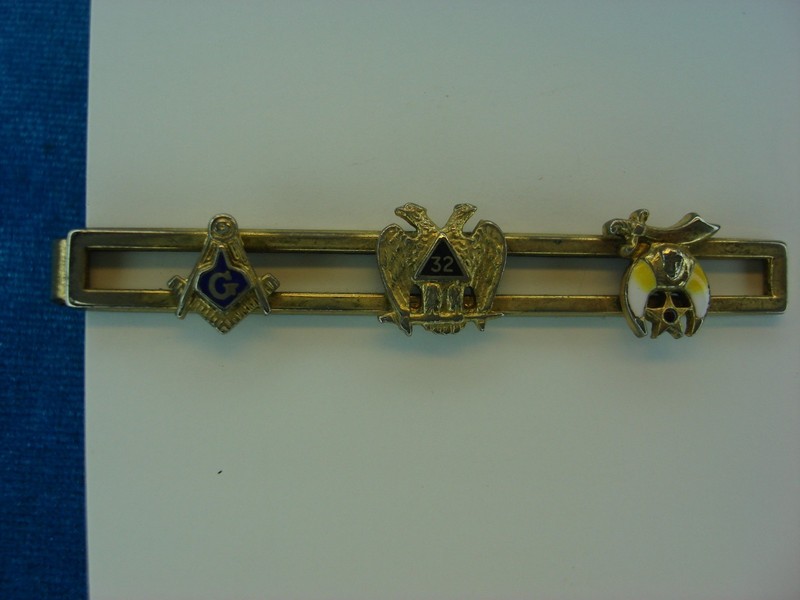 Vintage Masonic tie clip with enamel detailing of Freemasons, Shriners, and their symbols.