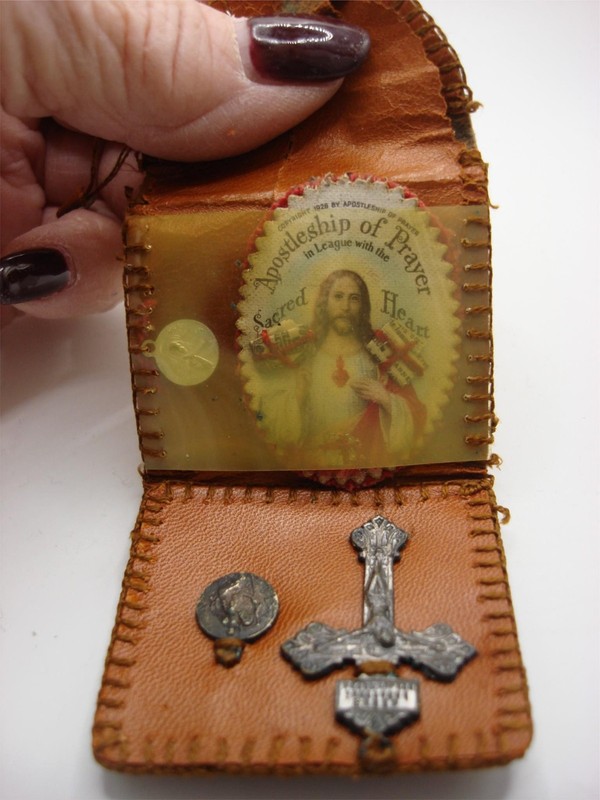 Vintage leather pocket reliquary with Sacred Heart image and religious medal, dated 1928