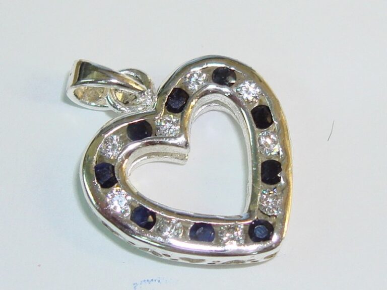 Sterling silver reversible heart pendant with blue topaz and clear quartz