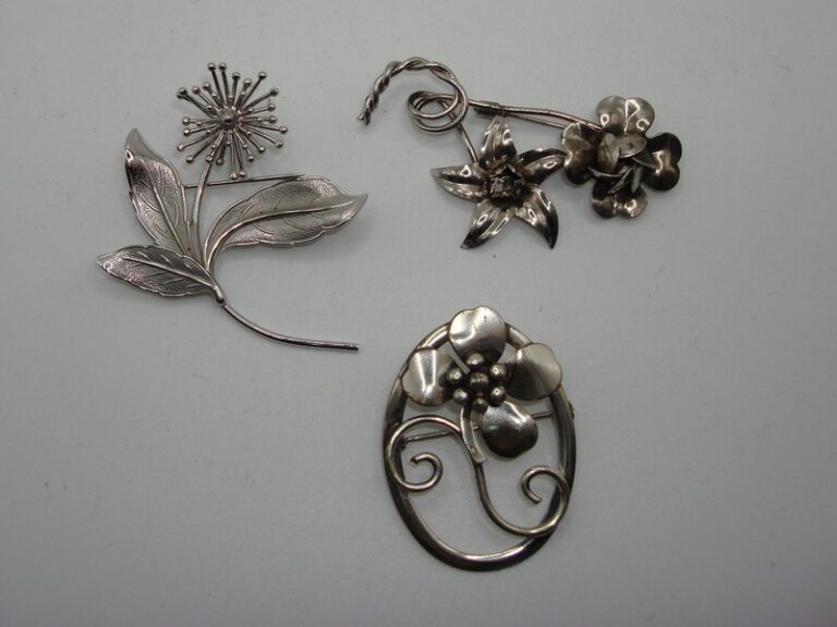 Vintage sterling silver floral pins, a set of three with hallmarks 'STERLING', 'JEWELART', and 'BEAU STERLING'