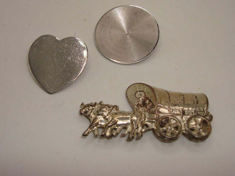 Vintage 1960s sterling silver pin set featuring a stagecoach, heart, and record designs.
