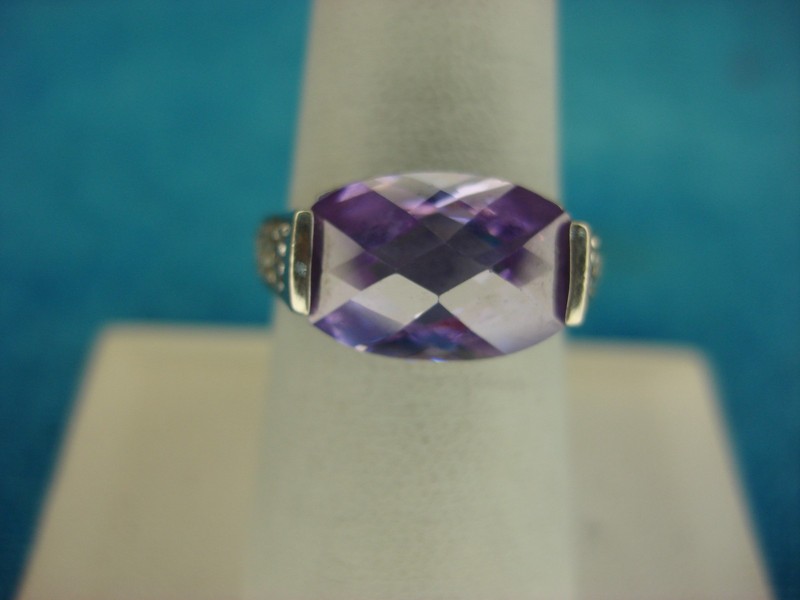 Sterling silver ring with a domed purple stone and cubic zirconia accents, size 8