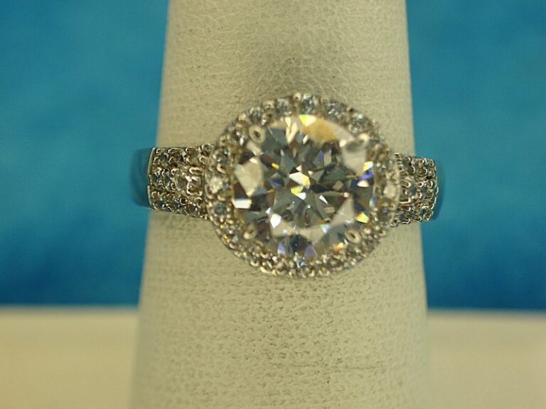 Sterling silver ring with large round simulated diamond and side stones, size 7