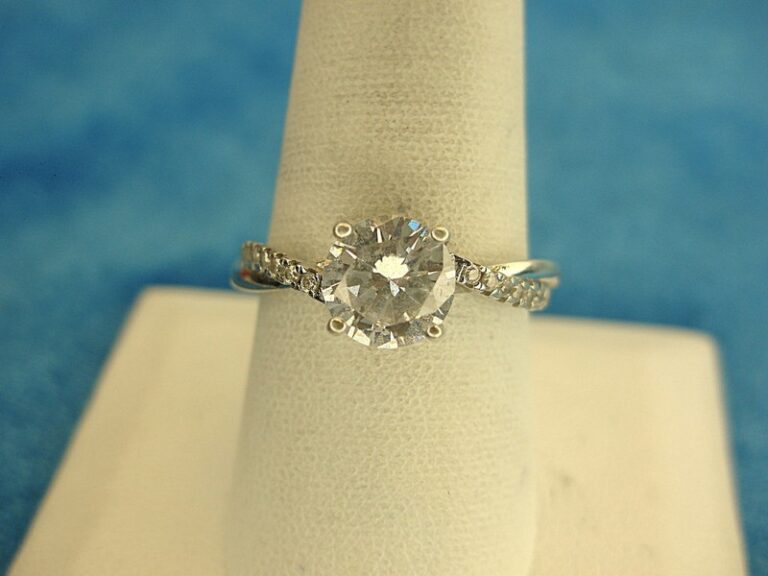 Sterling silver ring with simulated diamond and side stones, size 9