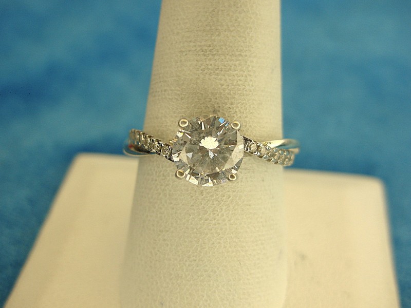 Sterling silver ring with simulated diamond and side stones, size 9