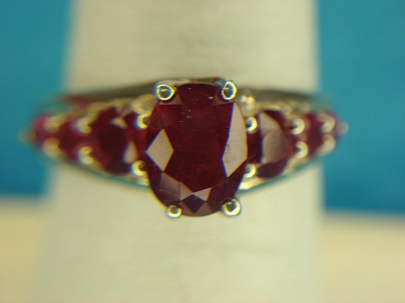 Sterling silver ring with a red oval gemstone and accent stones, size 7 1/2