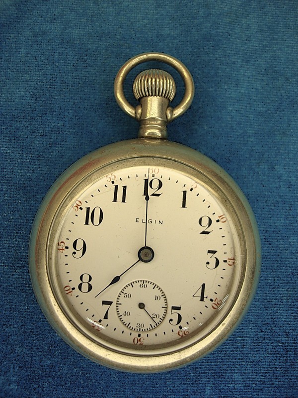 Vintage Elgin pocket watch with a steam locomotive design on the back cover.