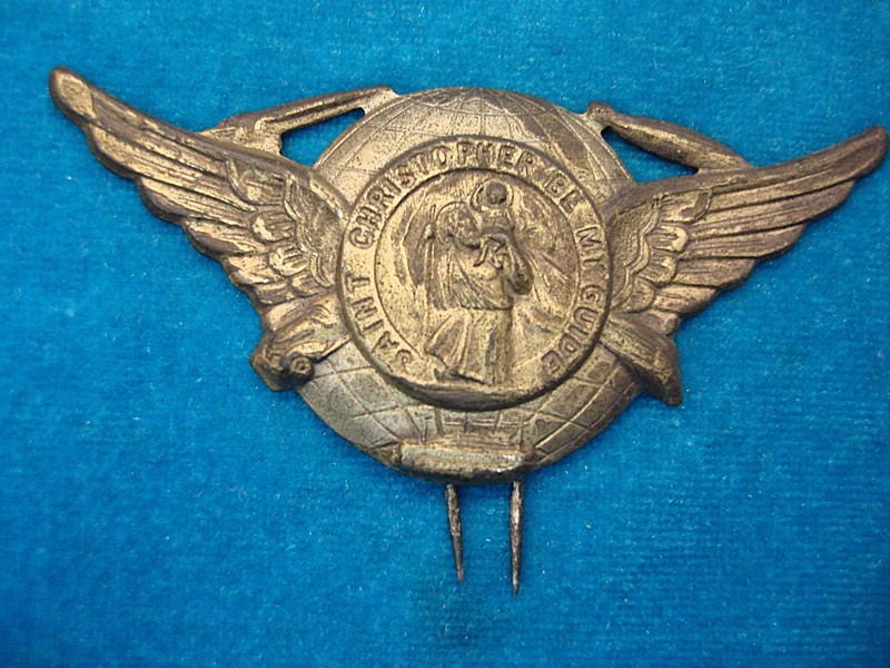 Vintage WWII St. Christopher Badge with car, train, blimp, ship, and plane icons.