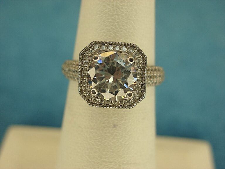 Sterling silver ring with a large simulated diamond and smaller accent stones, size 5.5