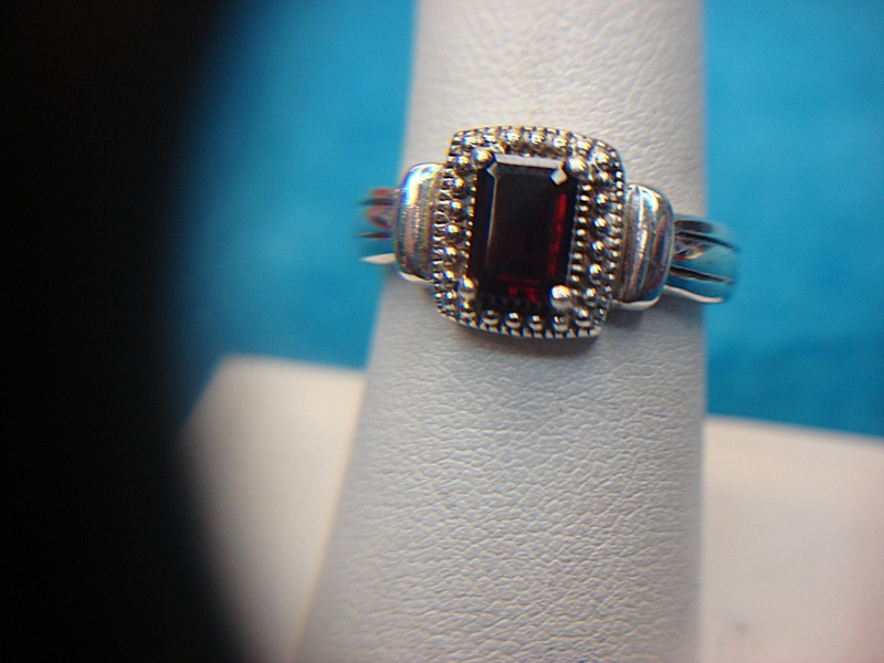 Sterling silver ring with emerald cut red stone, size 7.5