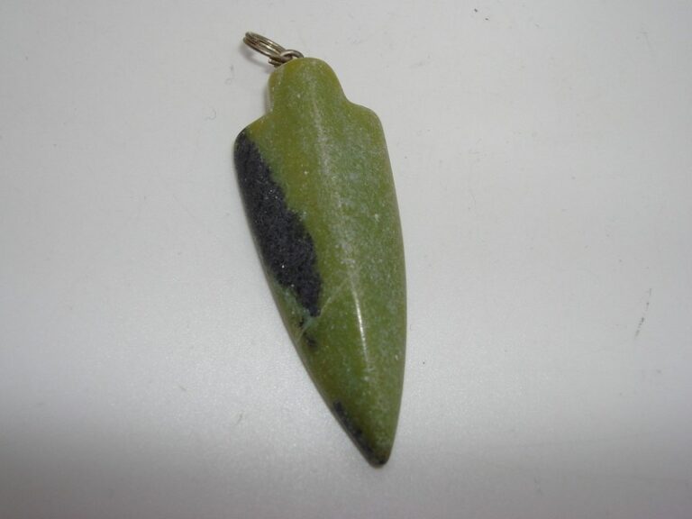 Vintage green jade arrowhead pendant, intricately carved