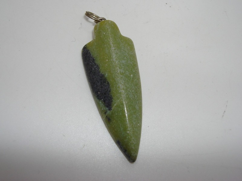 Vintage green jade arrowhead pendant, intricately carved