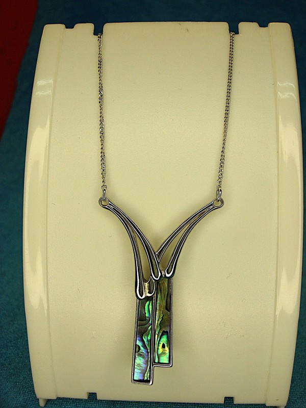 Abalone shell pendant necklace with a polished silver tone chain