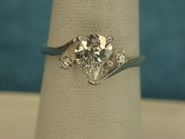 Sterling silver ring with a pear-shaped simulated diamond and accent stones