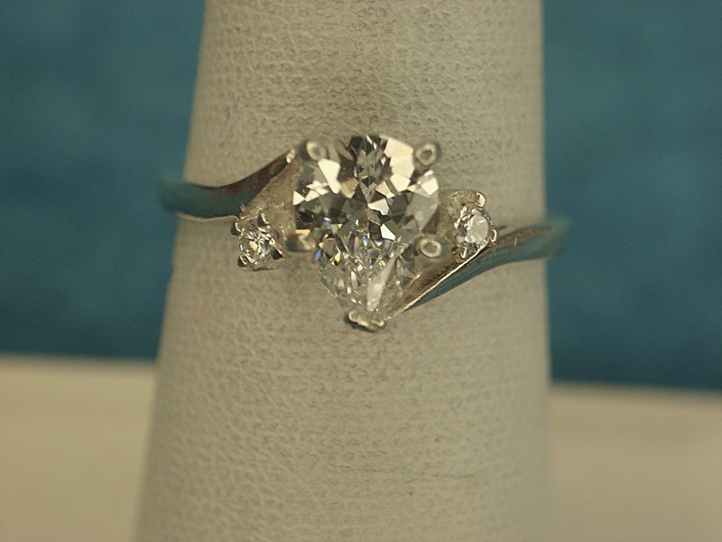 Sterling silver ring with a pear-shaped simulated diamond and accent stones