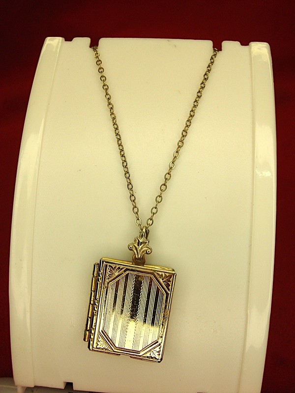Vintage gold tone book locket necklace, holds two photos