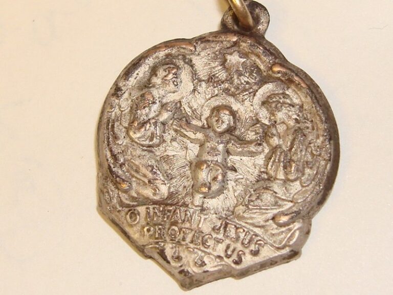 Vintage Infant Jesus medal with inscription 'Protect Us'