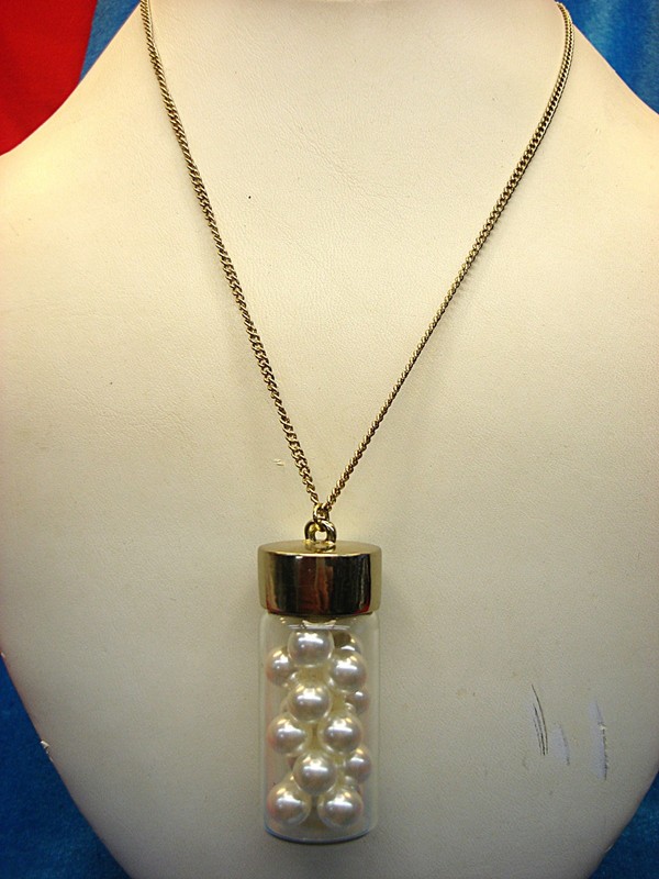 Vintage bottle of pearls necklace with a glass pendant and gold chain