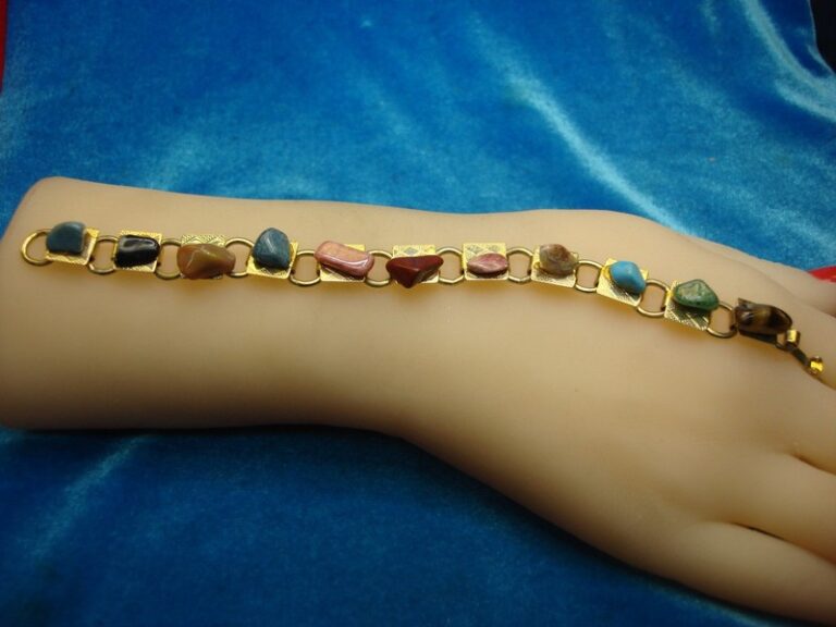 Gold tone bracelet with eleven natural gemstones
