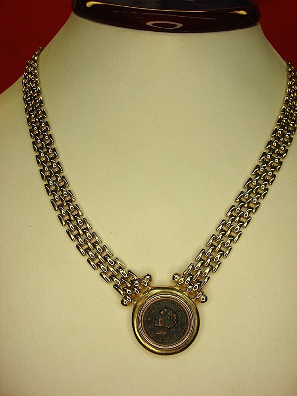 Gold tone choker necklace with a replica Roman copper coin pendant