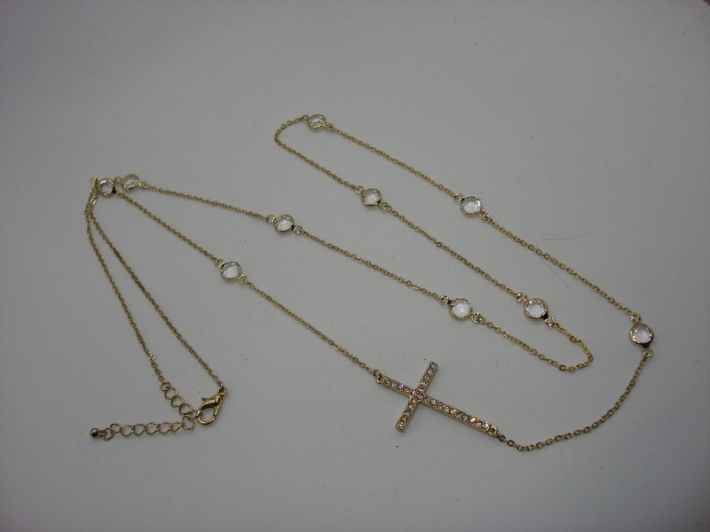 Vintage gold tone sideways cross necklace with sparkling clear glass stones