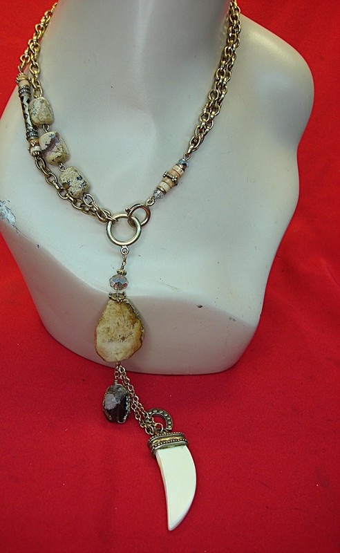 Vintage gold tone necklace with gemstones and a unique tooth pendant