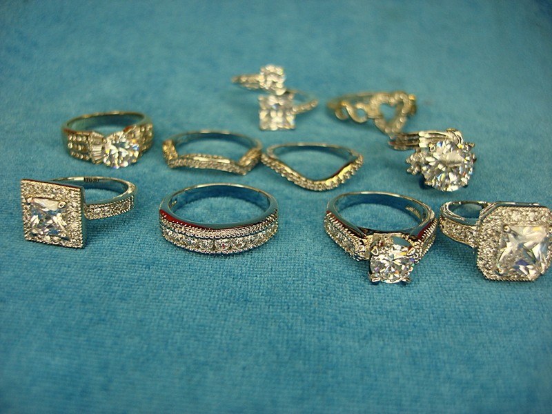 Set of 10 costume rings for women, sizes 6-10. Sparkling simulated diamonds and unique designs.