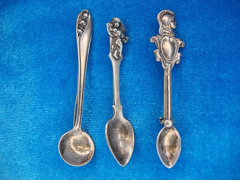 Three vintage sterling silver spoon pins, each with unique floral designs