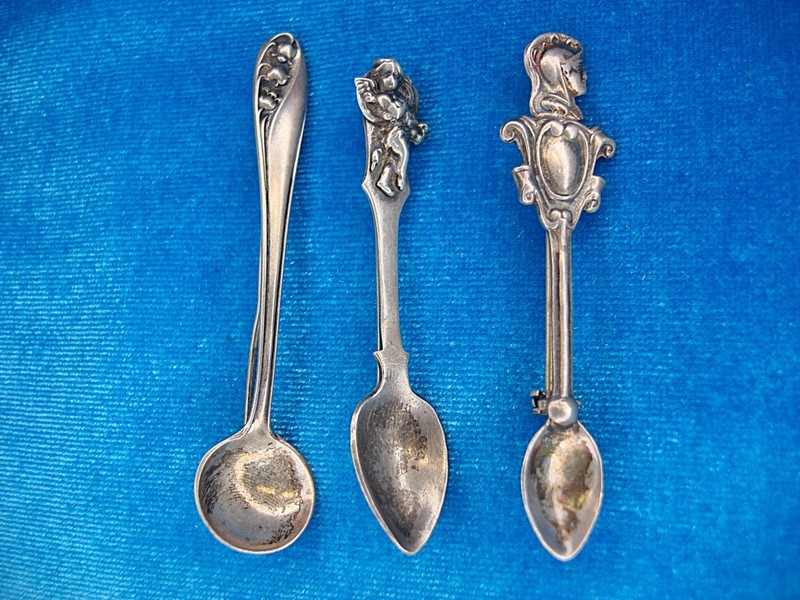 Three vintage sterling silver spoon pins, each with unique floral designs