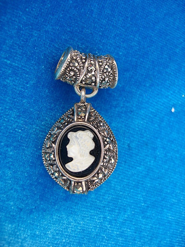 Vintage sterling silver cameo pendant with marcasite accents and mother-of-pearl inlay