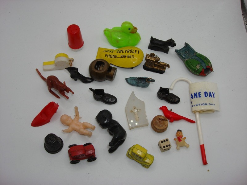 Collection of 24 vintage Cracker Jack prizes and collectibles, including miniature toys, figurines, and Americana finds.