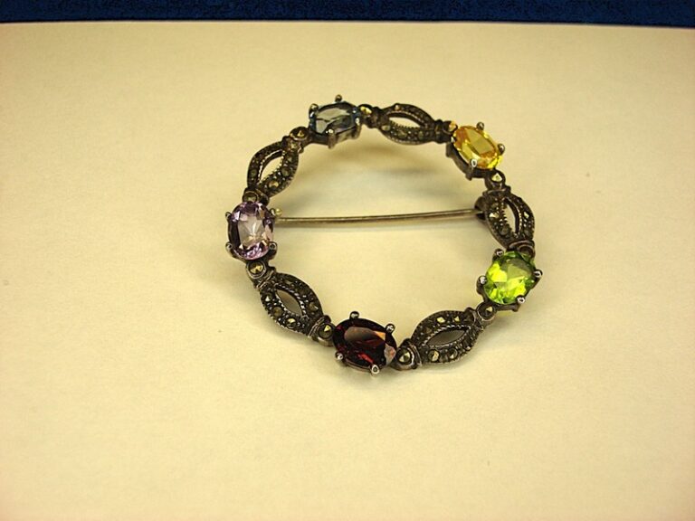 Vintage sterling silver circle pin with colorful gemstones and marcasites