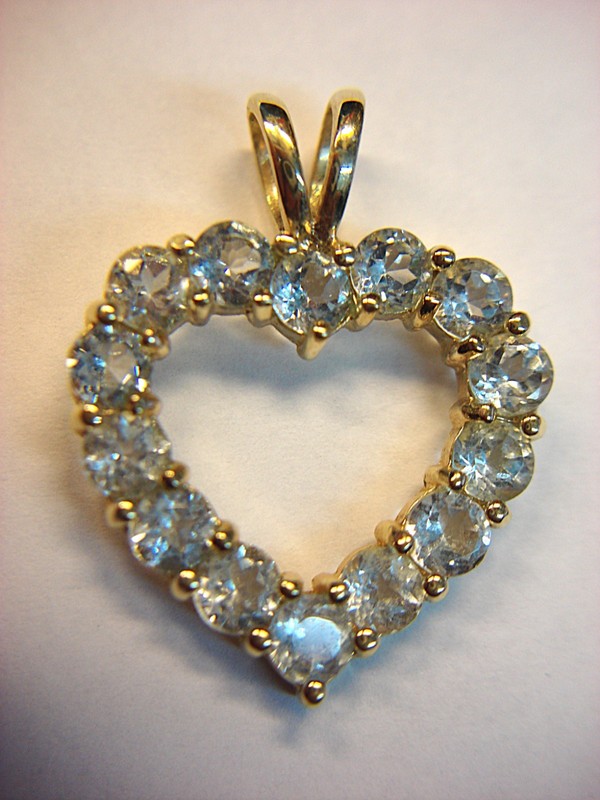 Sterling silver and gold vermeil heart pendant with light blue topaz gemstone
